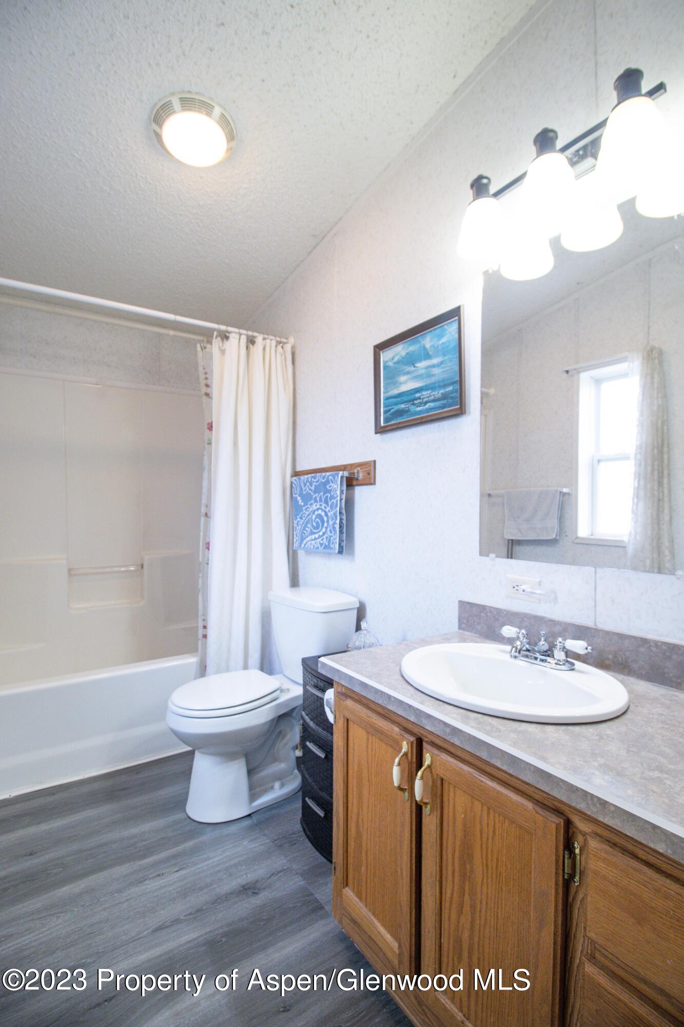 2345 County Road 306 Parachute, CO 81635 - Photo 10 of 29 a bathroom with a sink a toilet and a bathtub