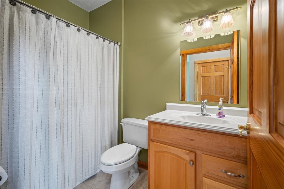 216 Old Wolf Hill Road Bethpage, TN 37022 - Photo 30 of 70 a bathroom with a granite countertop sink toilet and mirror