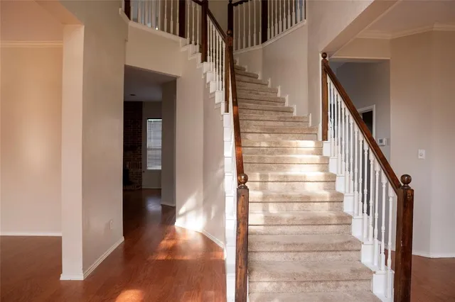 a view of entryway and hall with wooden floor