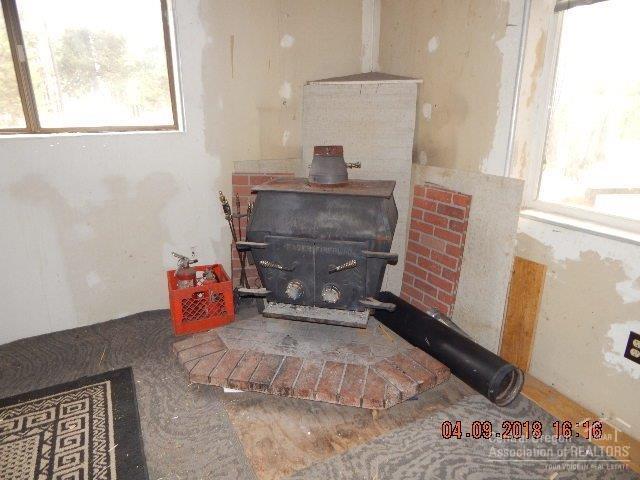 52740 Day Road La Pine, OR 97739 - Photo 5 of 11 Old uncertified wood stove inside.