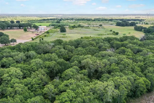 an aerial view of a city with lots of residential buildings and ocean view