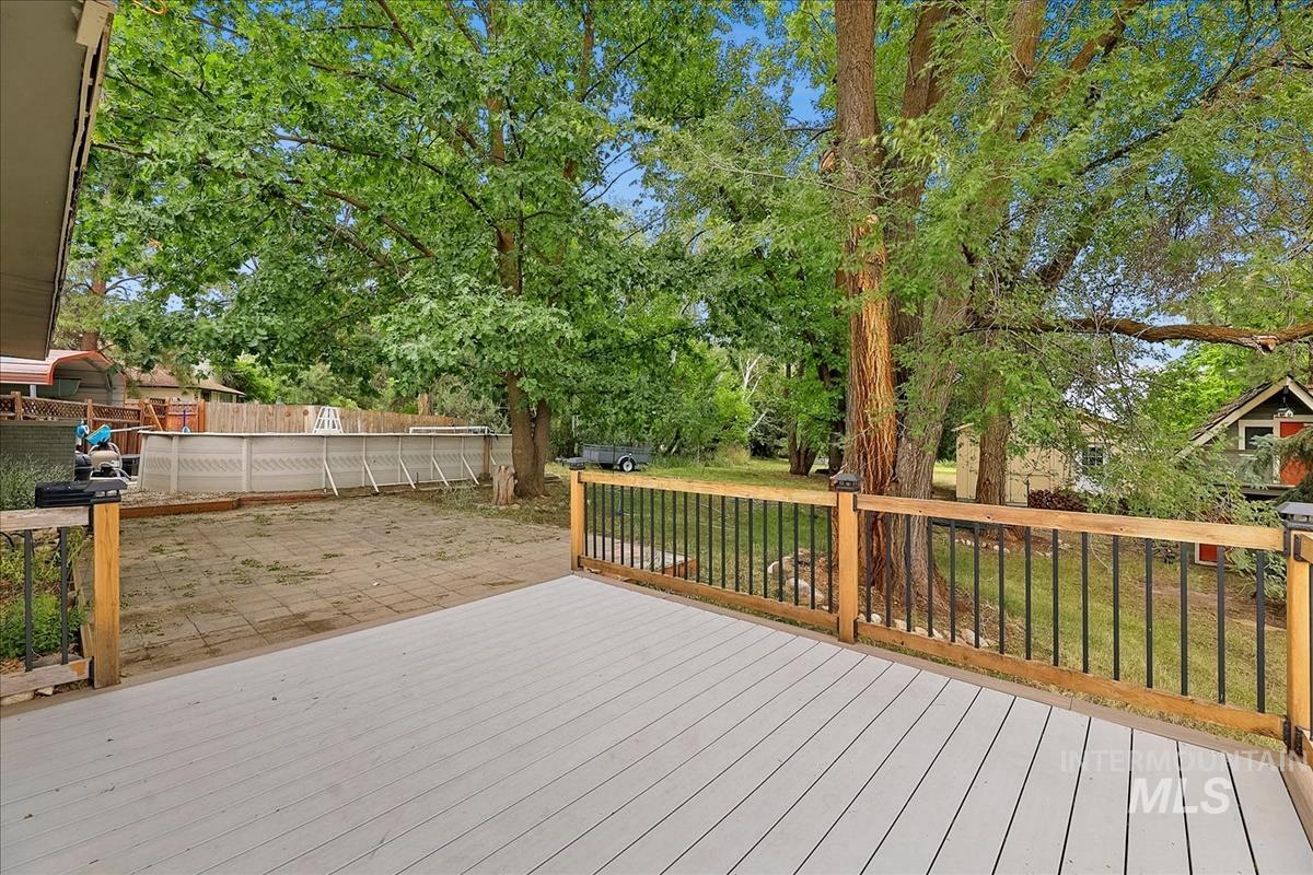 7141 West Hill Road Boise, ID 83714 - Photo 23 of 28 Expansive rear patio featuring square pavers and a raised wood-decked area
