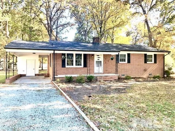 front view of a house with a dry trees