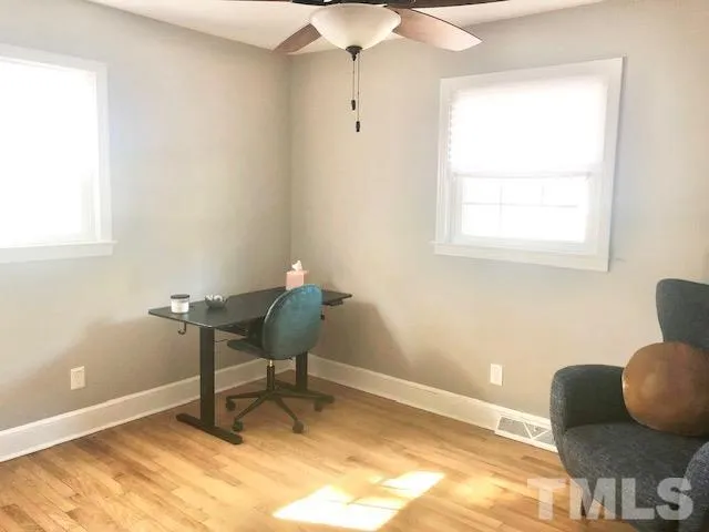 a workspace room with furniture and a window
