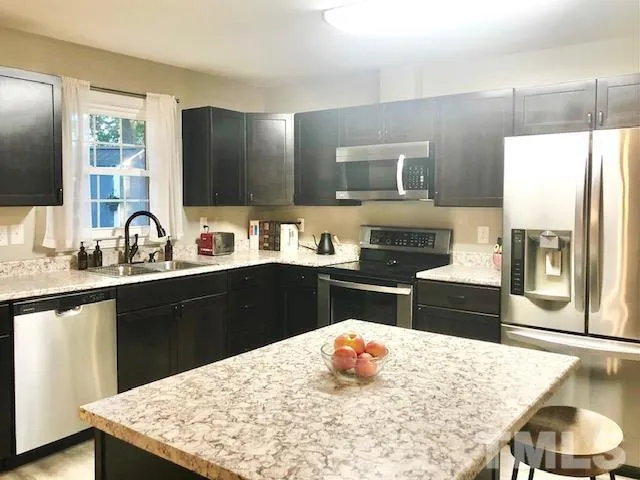 a kitchen with a sink a stove and refrigerator