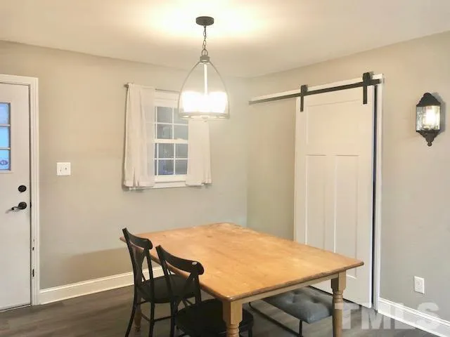 a view of a dining room with furniture wooden floor and chandelier