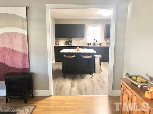 a room with a chair and a fireplace with wooden floor