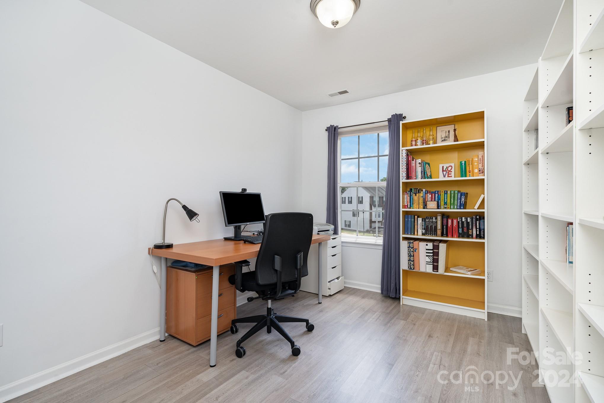 1912 Travertine Lane Fort Mill, SC 29708 - Photo 15 of 25 a view of a workspace with furniture and wooden floor