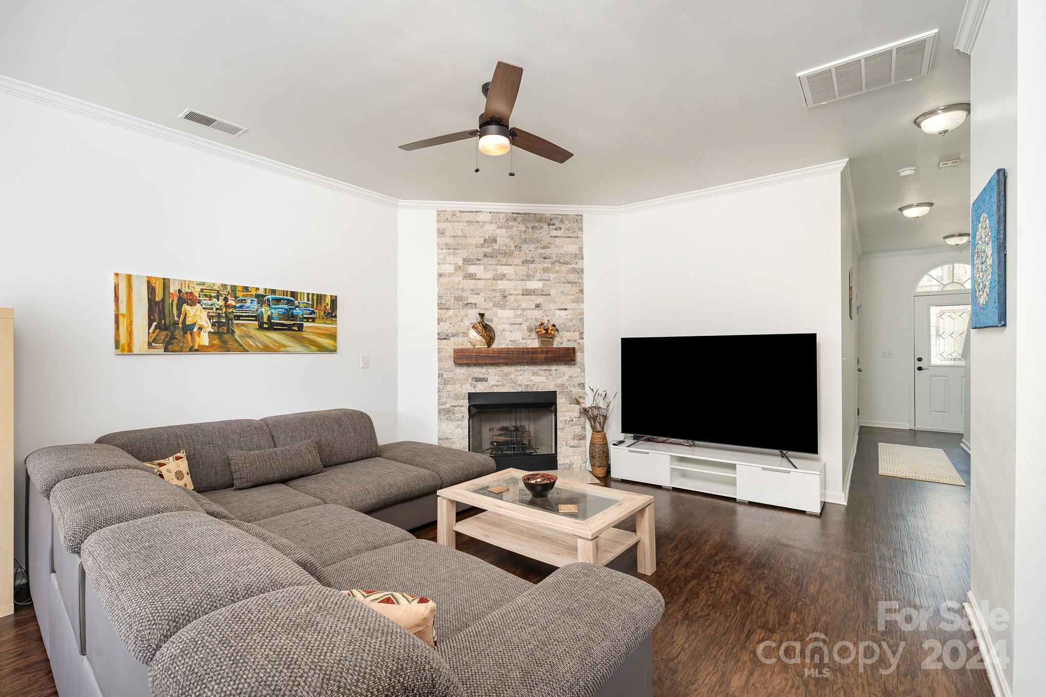 1912 Travertine Lane Fort Mill, SC 29708 - Photo 3 of 25 a living room with furniture a fireplace and a flat screen tv
