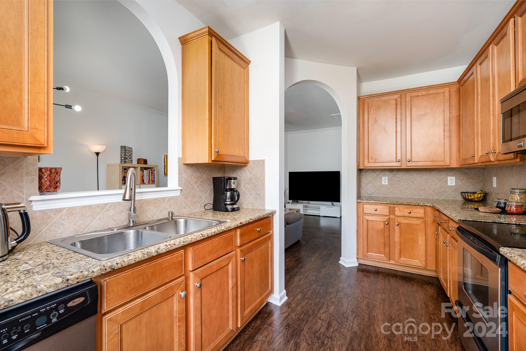 1912 Travertine Lane Fort Mill, SC 29708 - Photo 7 of 25 a kitchen with stainless steel appliances granite countertop a sink a stove cabinets counter space and a window