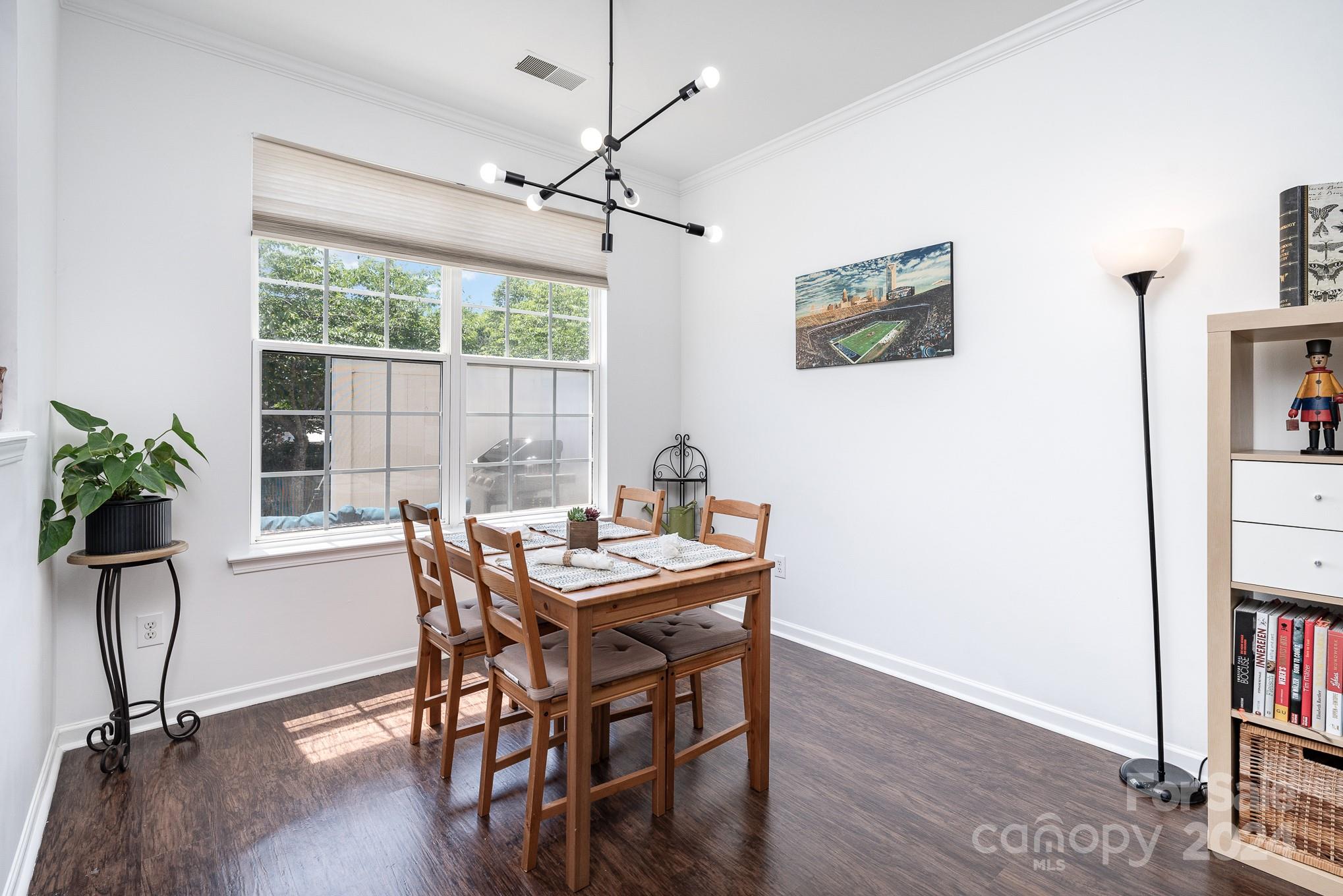 1912 Travertine Lane Fort Mill, SC 29708 - Photo 8 of 25 a view of a dining room with furniture window and wooden floor