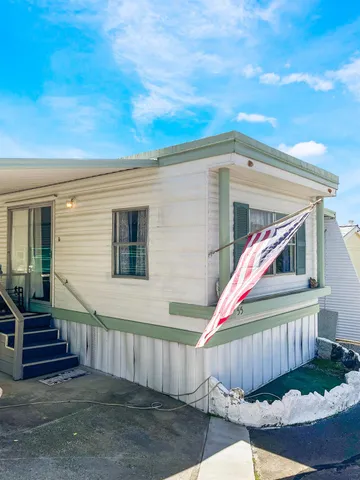 a view of a house with a backyard and stairs