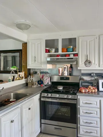 a kitchen with a stove and a sink