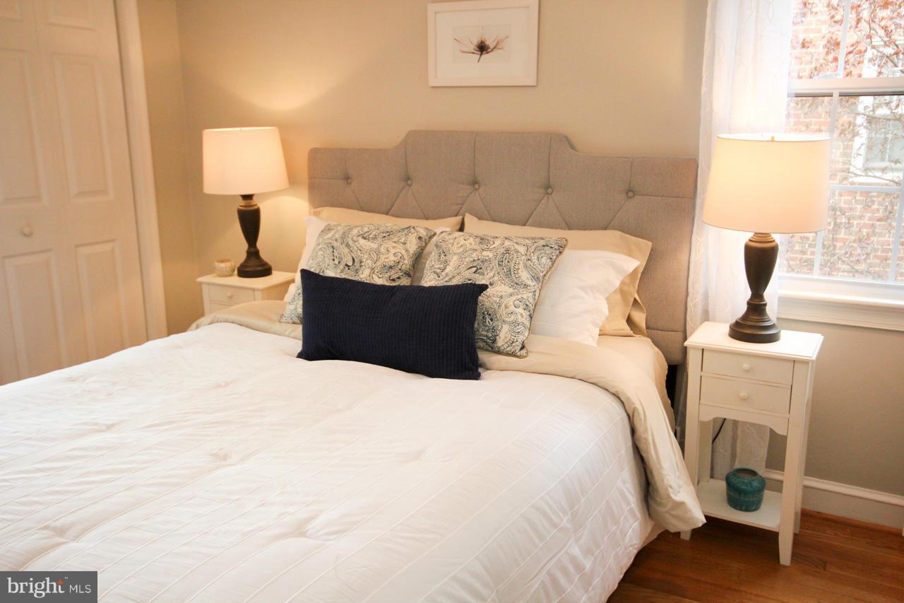 9129 Eton Road Silver Spring, MD 20901 - Photo 22 of 29 a large bed sitting in a bedroom next to a window and lamp