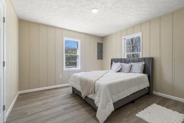 a large bed sitting in a bedroom next to a window