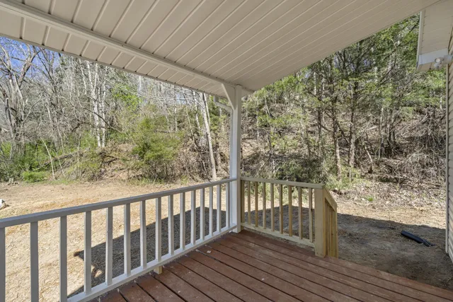 a view of a porch with wooden floor