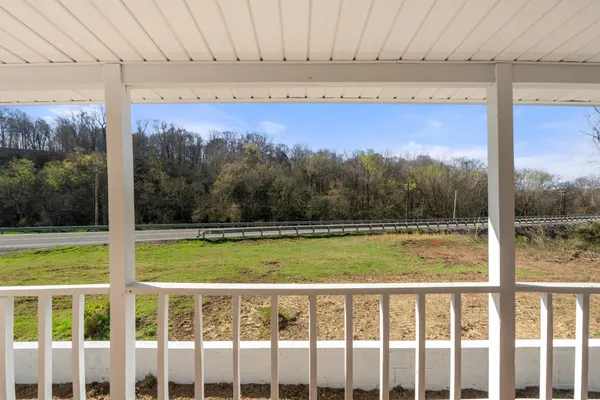 a view of a room with a large window and a yard