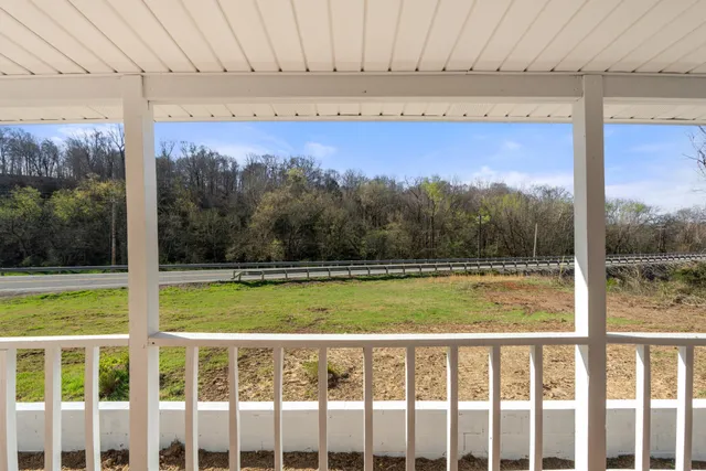 a view of a room with a large window and a yard