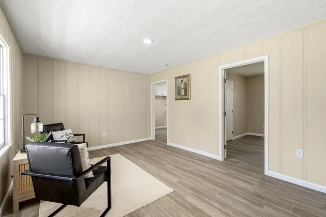 a view of a workspace with furniture and wooden floor