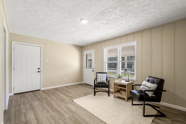 a workspace with wooden floor and a window
