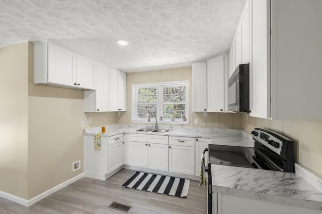 a kitchen with a sink stove and cabinets