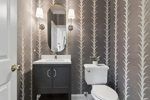 a bathroom with a toilet sink and mirror