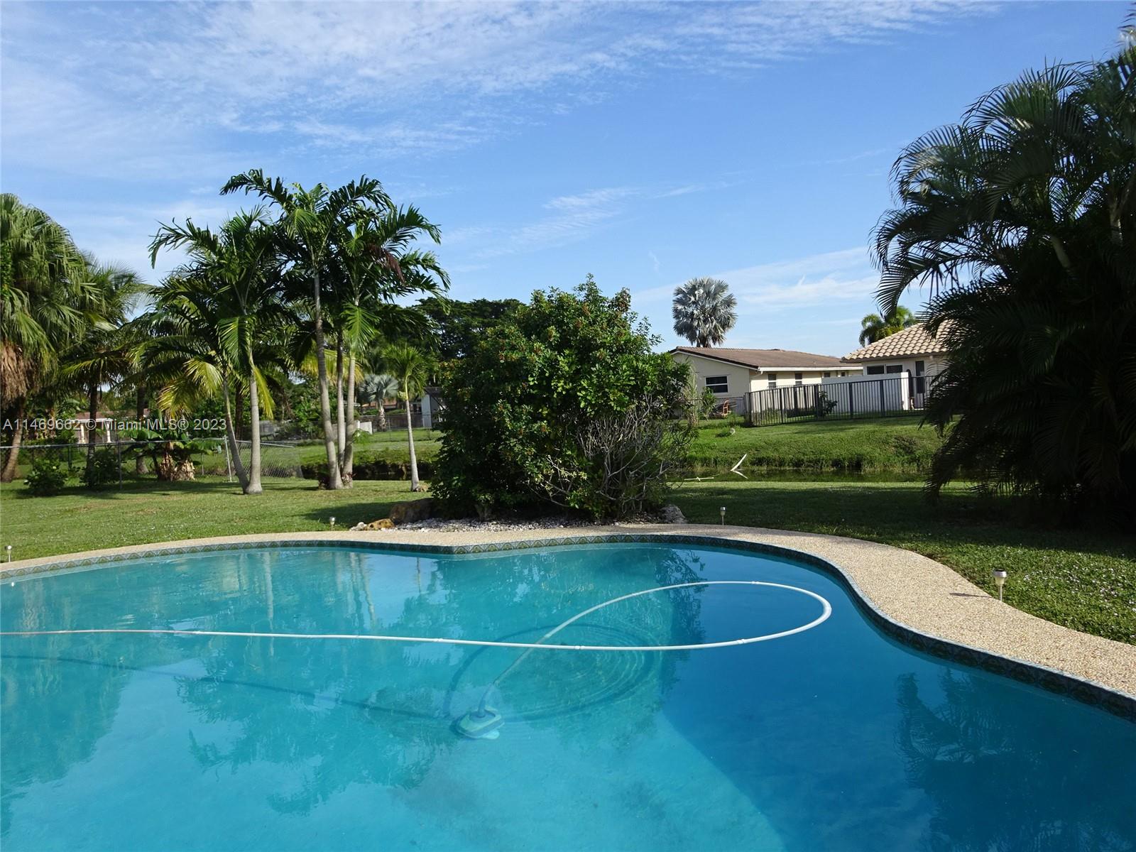 a view of a swimming pool and a yard