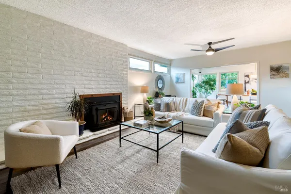 a living room with furniture wooden floor and a fireplace
