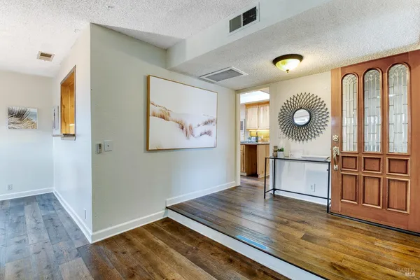 a kitchen with stainless steel appliances granite countertop a refrigerator a sink and a stove