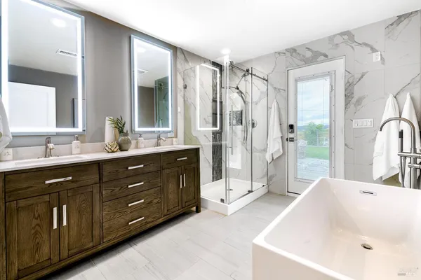 a bathroom with a shower and a glass door