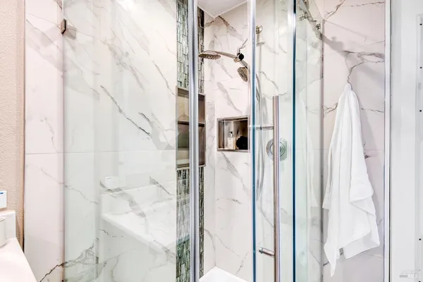 a spacious bathroom with a double vanity sink a mirror and a bathtub