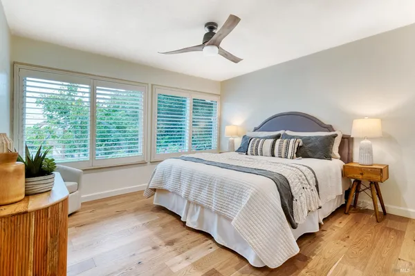 a spacious bedroom with a bed and a dresser