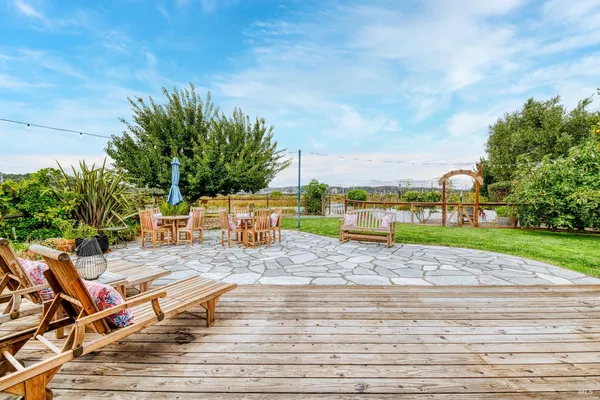 a view of a house with a yard and sitting area