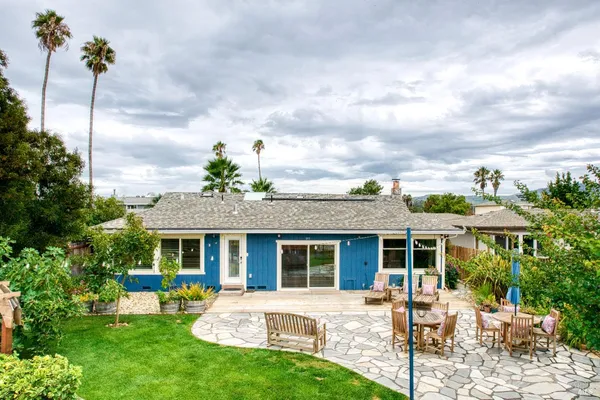 a view of a house with backyard sitting area and porch