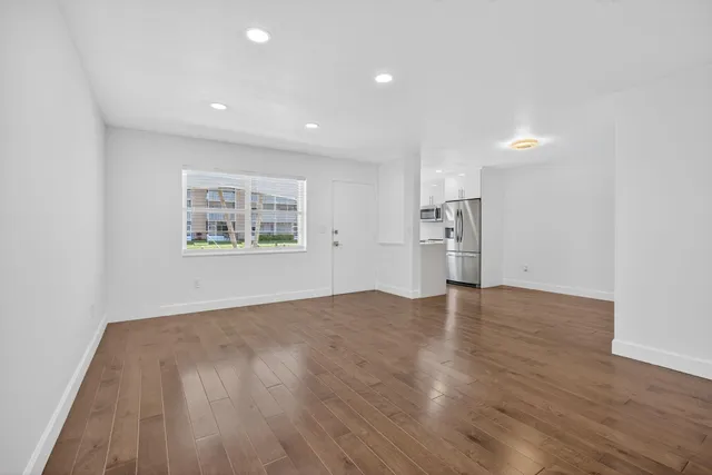 a kitchen with stainless steel appliances a refrigerator and a stove top oven