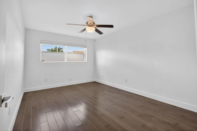 an empty room with windows and closet