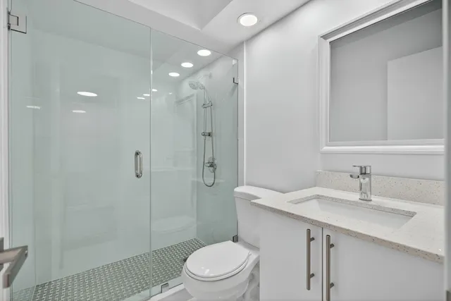 a backyard with table and chairs plants and wooden fence