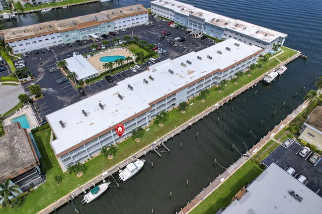 a front view of a house with garden and trees