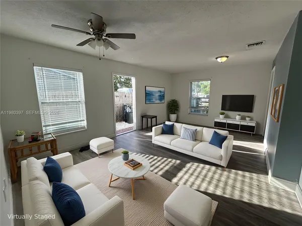 a living room with furniture and a flat screen tv