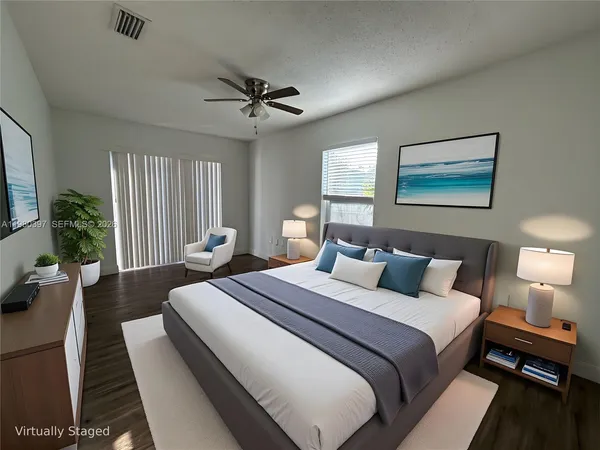 a bedroom with bed and a chandelier