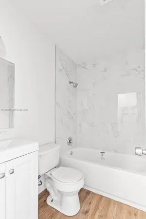 a bathroom with a toilet a sink and a bathtub