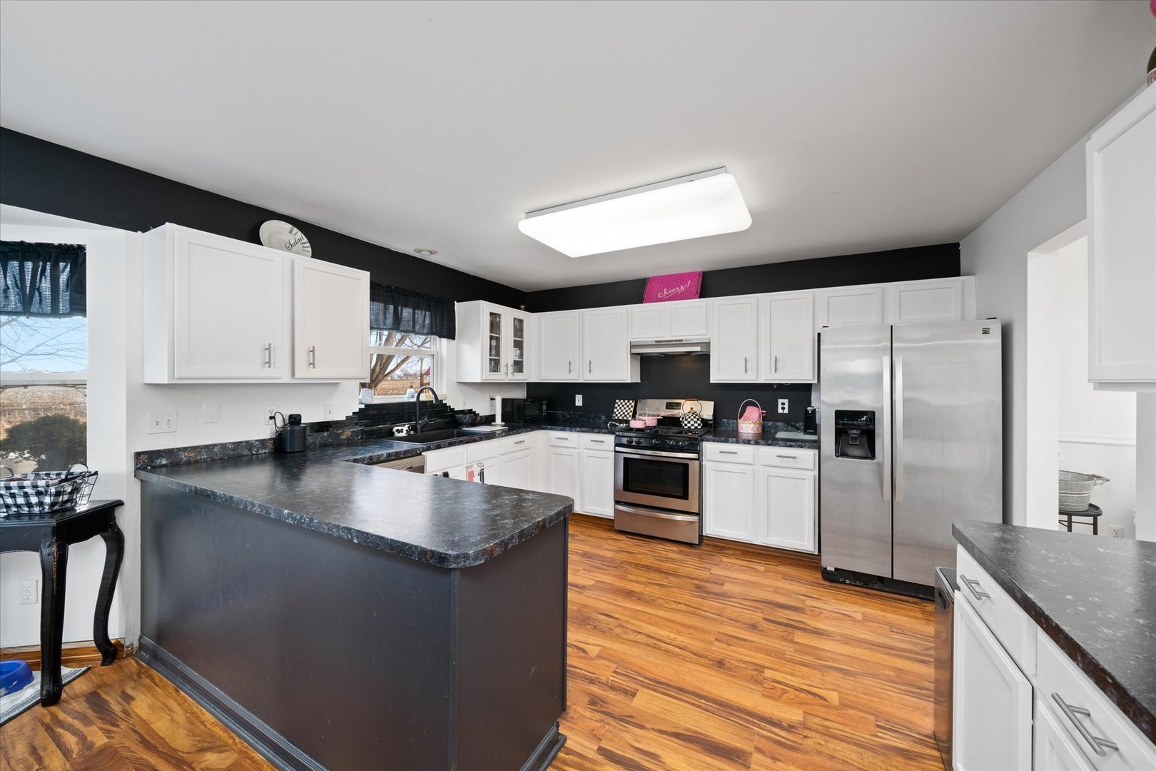 376 Brookhaven Circle Sugar Grove, IL 60554 - Photo 11 of 33 a kitchen with granite countertop a refrigerator a sink dishwasher a stove top oven a dining table and chairs with wooden floor