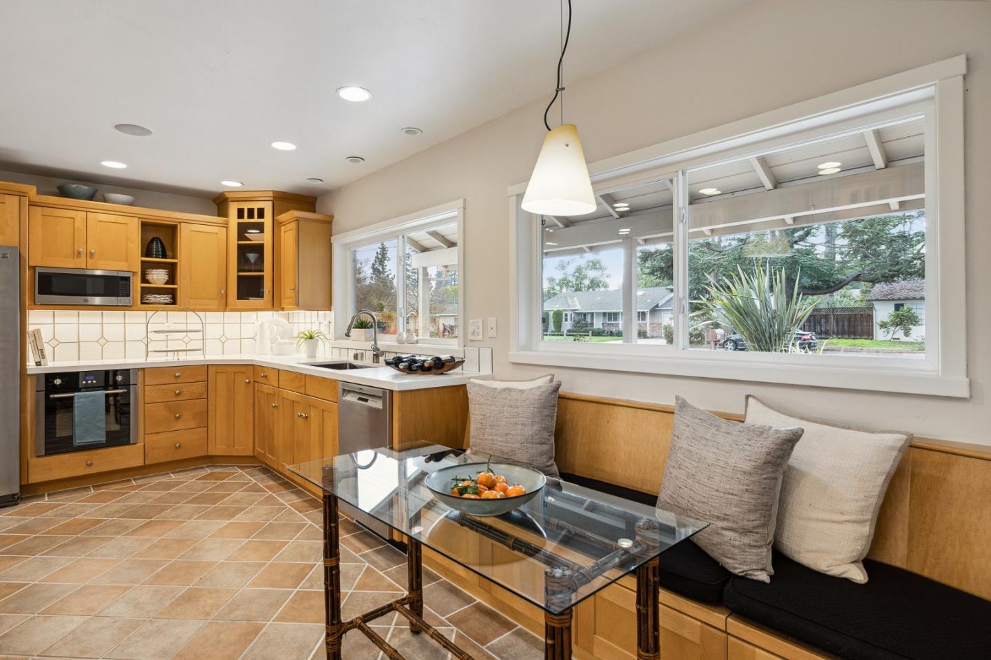 671 Covington Road Los Altos, CA 94024 - Photo 16 of 38 a open kitchen with stainless steel appliances granite countertop a stove top oven a sink dishwasher and white cabinets with wooden floor