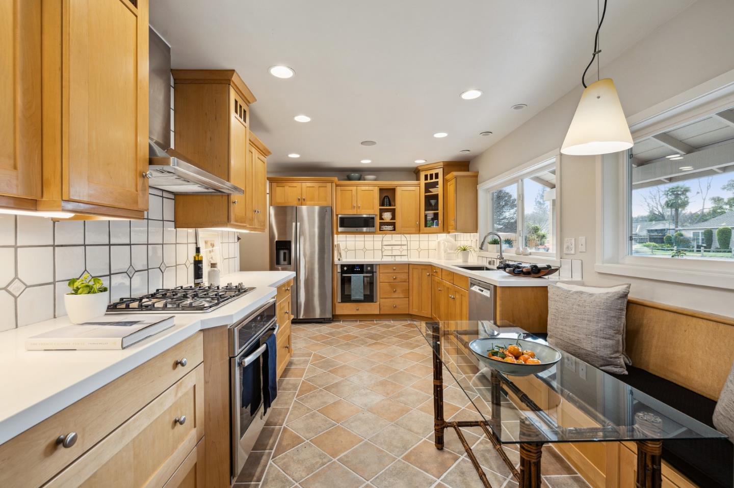 671 Covington Road Los Altos, CA 94024 - Photo 17 of 38 a kitchen with stainless steel appliances granite countertop a sink stove and refrigerator