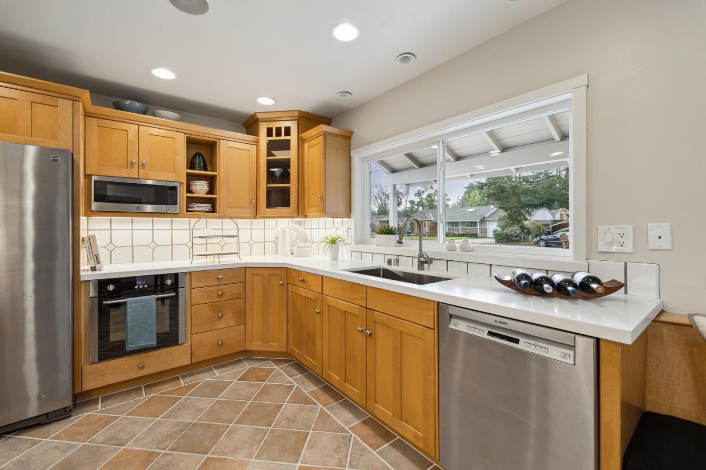 671 Covington Road Los Altos, CA 94024 - Photo 18 of 38 a kitchen with stainless steel appliances granite countertop a sink stove and refrigerator