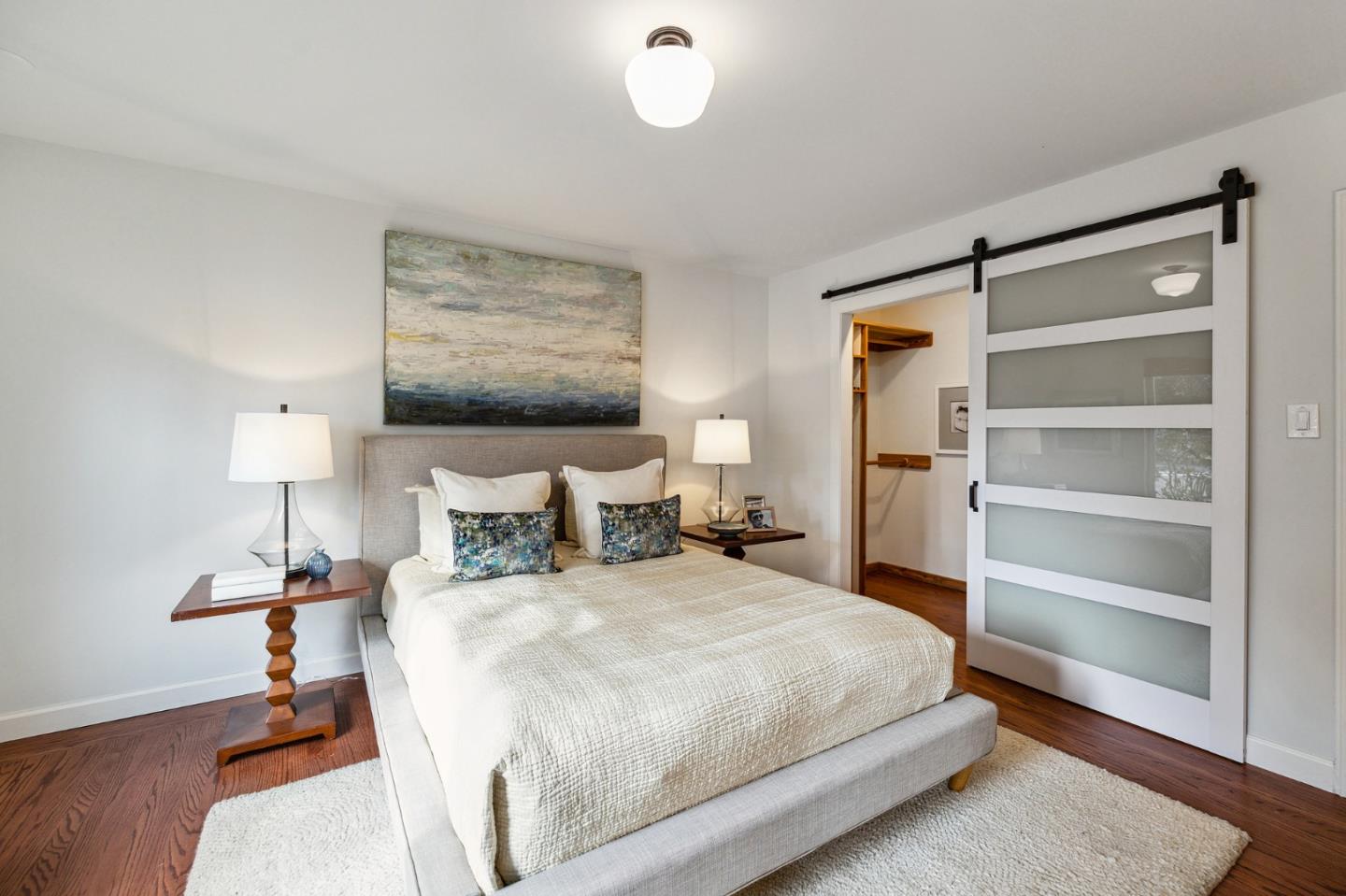 671 Covington Road Los Altos, CA 94024 - Photo 22 of 38 a bedroom with a bed and a lamp on table