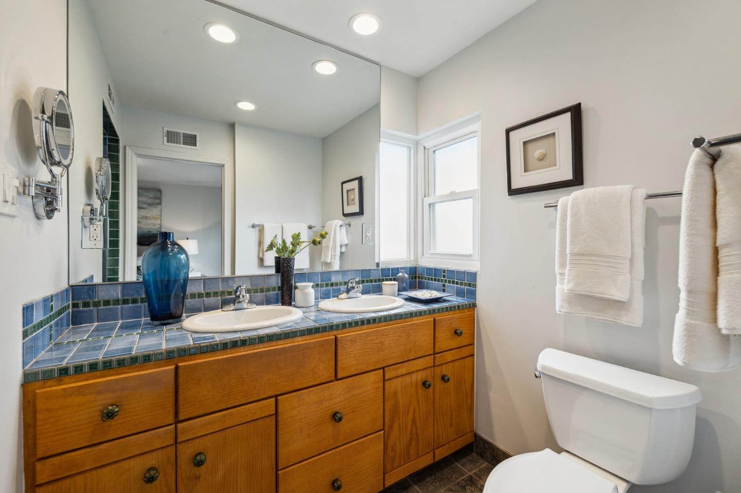 671 Covington Road Los Altos, CA 94024 - Photo 24 of 38 a bathroom with a granite countertop toilet sink and mirror