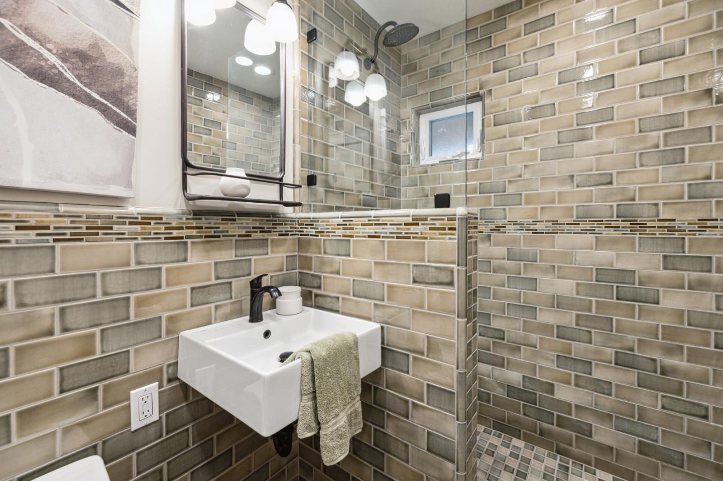 671 Covington Road Los Altos, CA 94024 - Photo 28 of 38 a bathroom with a sink a mirror and shower