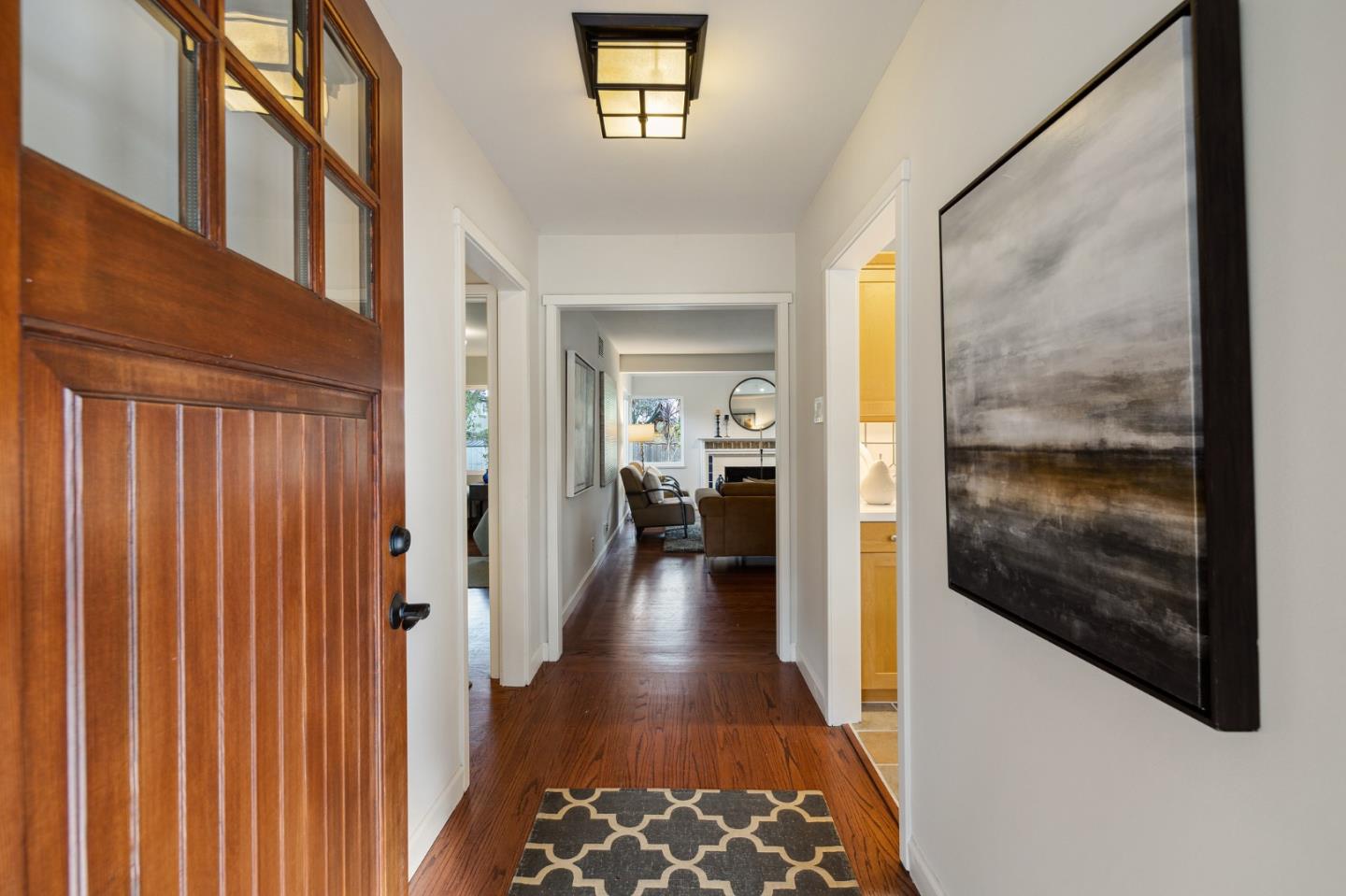 671 Covington Road Los Altos, CA 94024 - Photo 6 of 38 a view of a hallway with wooden floor and a living room