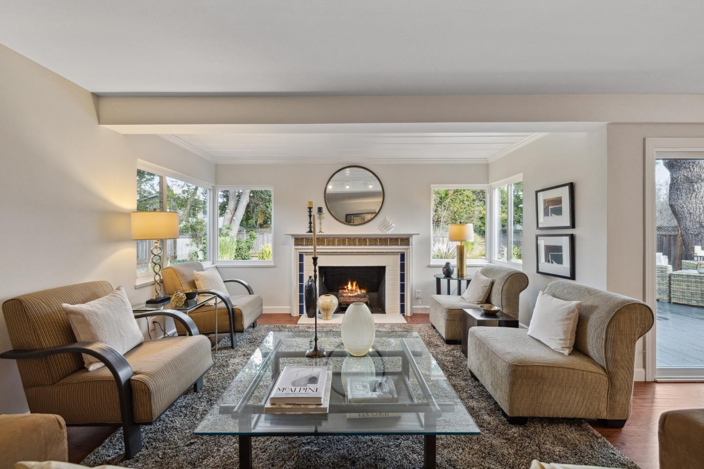 671 Covington Road Los Altos, CA 94024 - Photo 9 of 38 a living room with furniture a fireplace and a large window